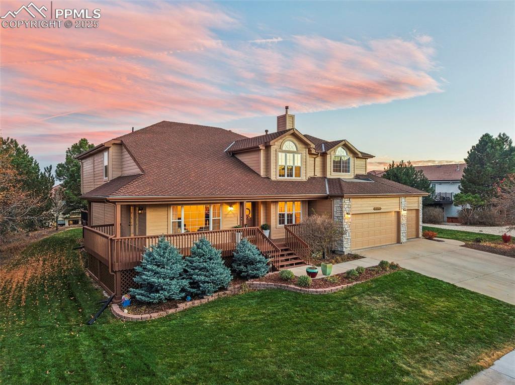 5575 Butler Court Colorado Springs, CO 80918 - Photo 2 of 50 a front view of a house with a garden and plants