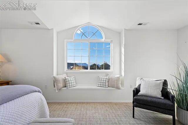 a view of bedroom with furniture and window