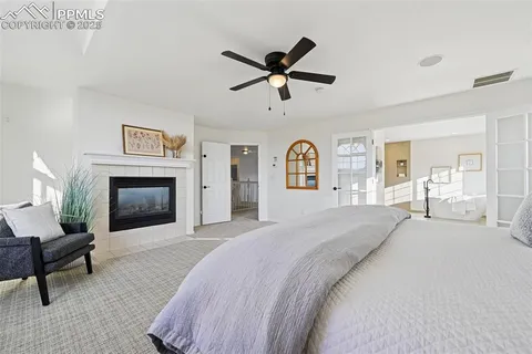 a spacious bedroom with a bed and a fireplace