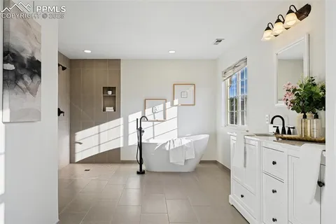 a spacious bedroom with a bed and a cabinets