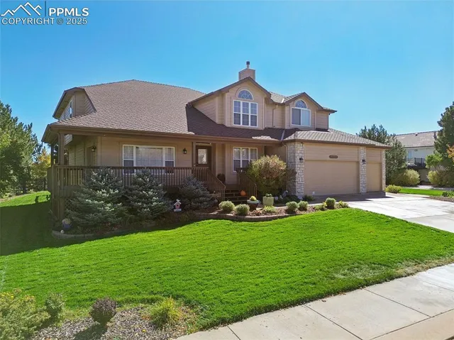 a front view of a house with garden and yard
