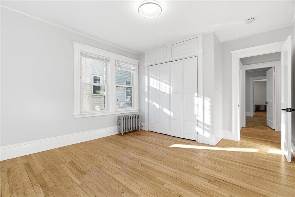 29-31 Edward T Sullivan Road, Unit 2 Cambridge, MA 02138 - Photo 16 of 34 a view of empty room with wooden floor and fan