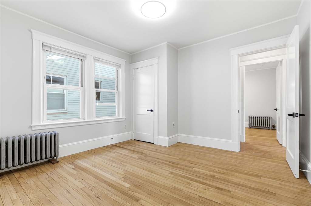 29-31 Edward T Sullivan Road, Unit 2 Cambridge, MA 02138 - Photo 18 of 34 a view of empty room with wooden floor and fan