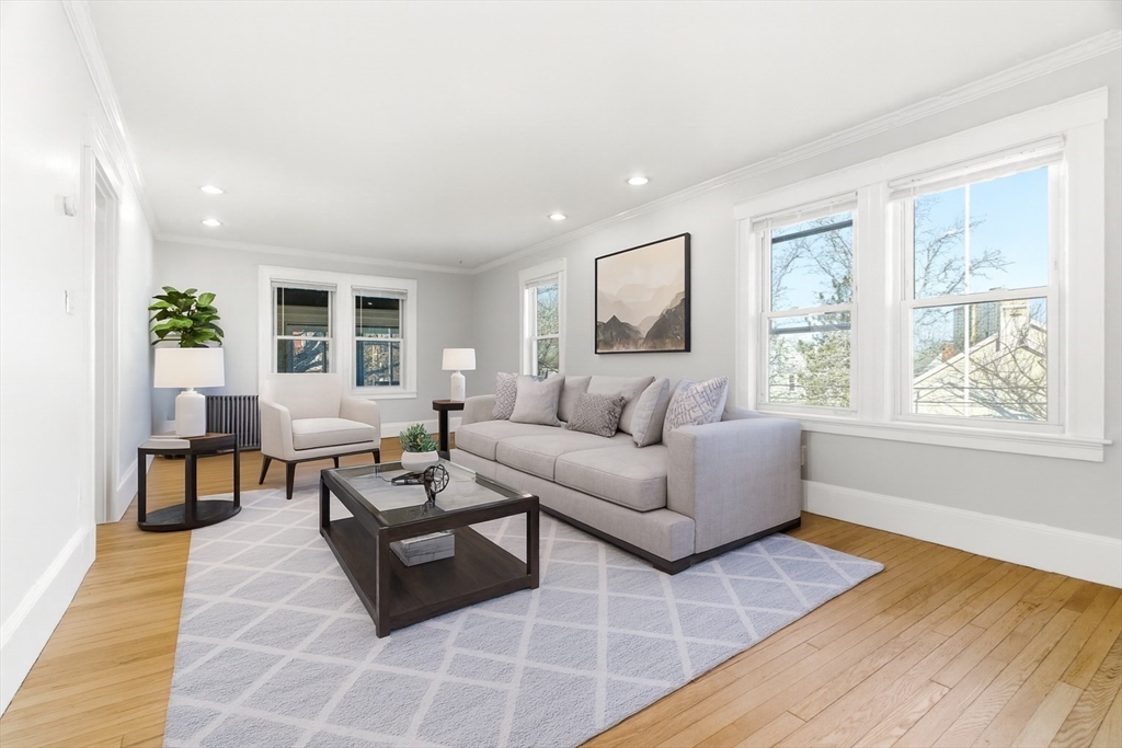 29-31 Edward T Sullivan Road, Unit 2 Cambridge, MA 02138 - Photo 2 of 34 a living room with furniture and a large window