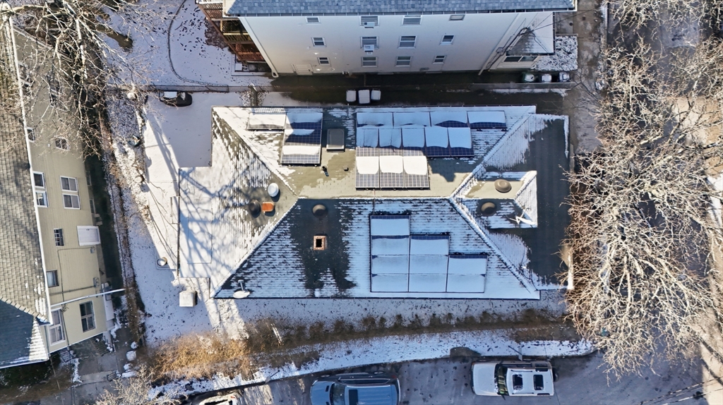 29-31 Edward T Sullivan Road, Unit 2 Cambridge, MA 02138 - Photo 25 of 34 an aerial view of a house with roof deck