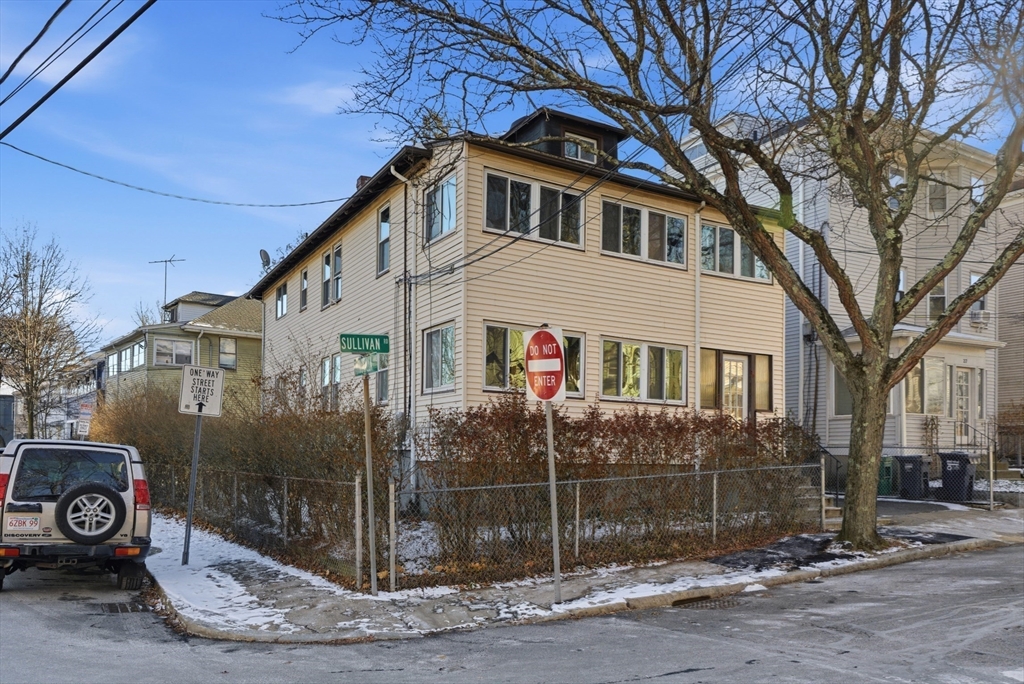 29-31 Edward T Sullivan Road, Unit 2 Cambridge, MA 02138 - Photo 29 of 34 a front view of a house with parking