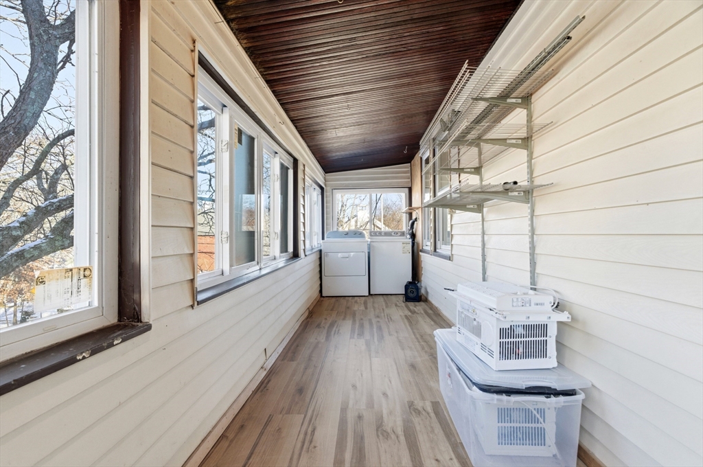 29-31 Edward T Sullivan Road, Unit 2 Cambridge, MA 02138 - Photo 34 of 34 a view of a porch with wooden floor and iron stairs