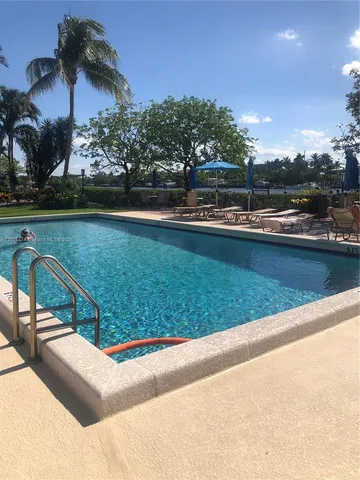 a view of a swimming pool and lounge chair