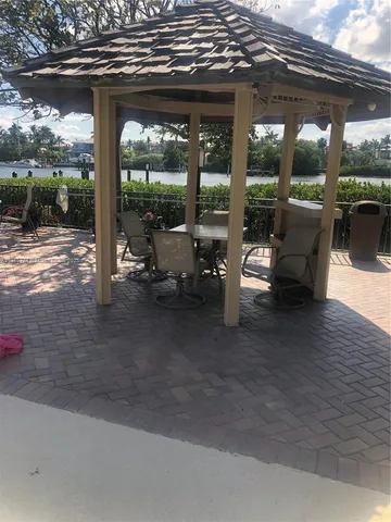 a building outdoor space with patio furniture and potted plants