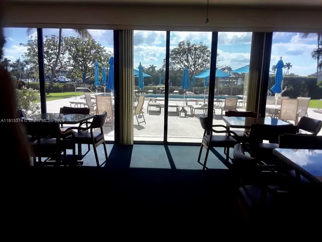 a view of a floor to dining room with furniture and floor to ceiling window