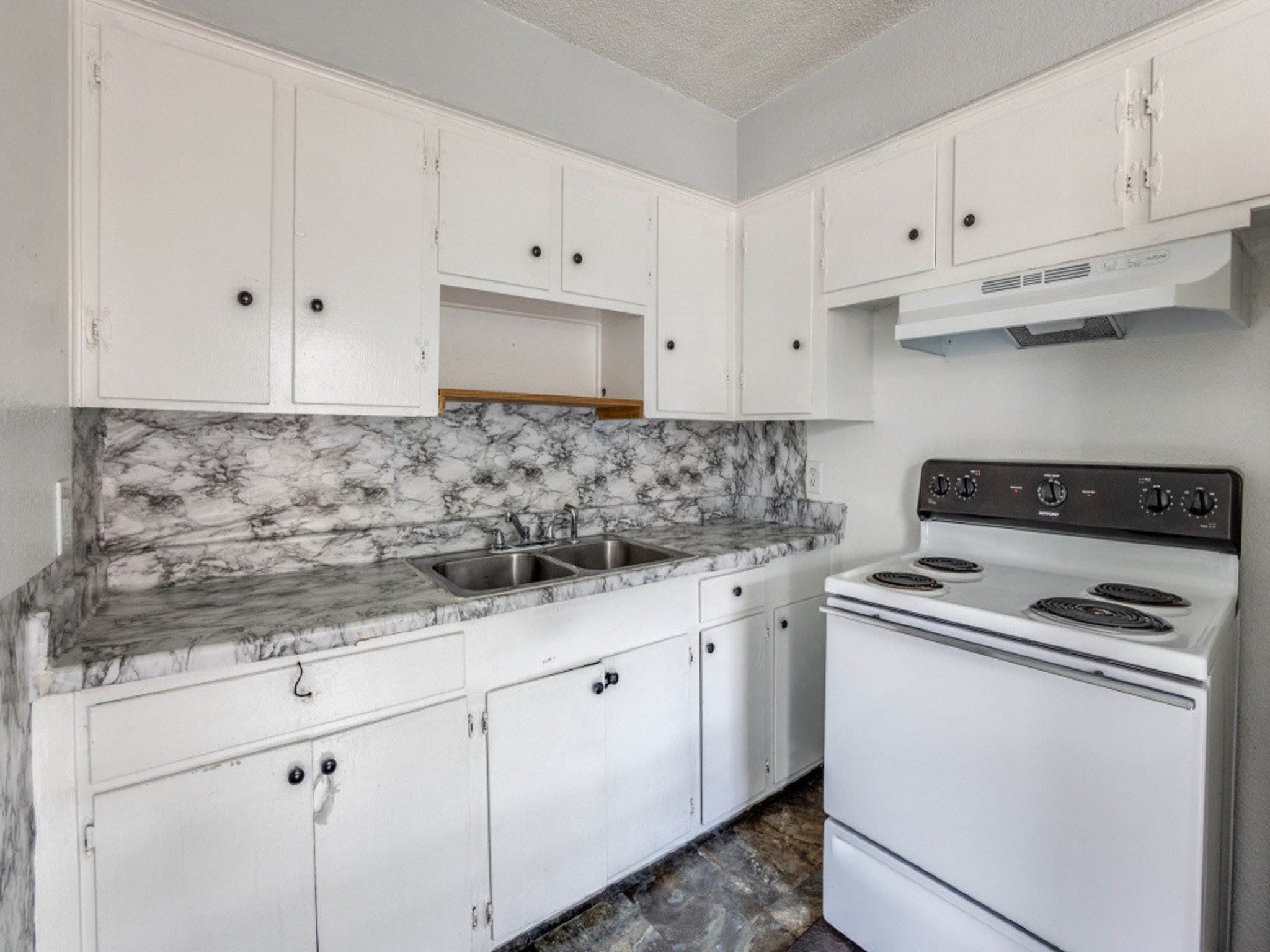 1711 Wichita Street, Unit 2 Houston, TX 77004 - Photo 12 of 12 a kitchen with granite countertop white cabinets and white appliances