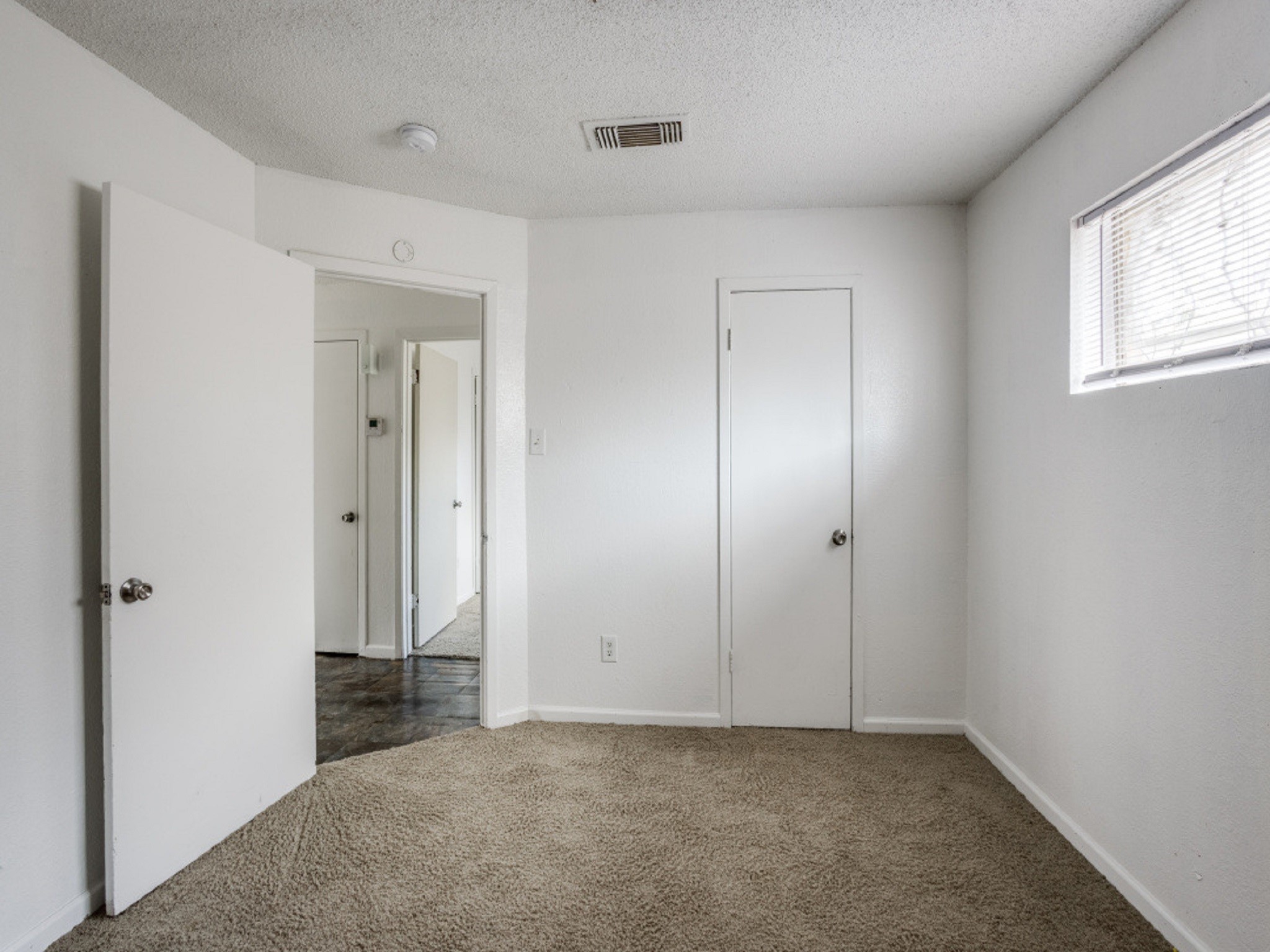 1711 Wichita Street, Unit 2 Houston, TX 77004 - Photo 8 of 12 an empty room with windows and closet