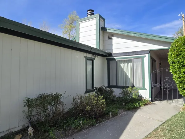 a view of a house with brick walls and plants