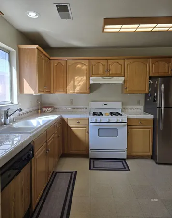 a kitchen with a sink stove and cabinets