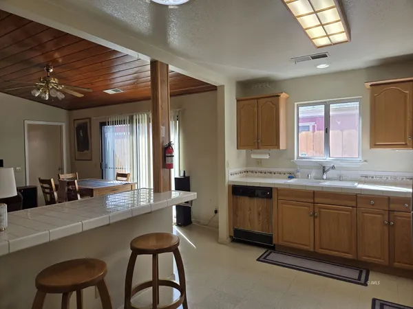 a large kitchen with a table and chairs in it