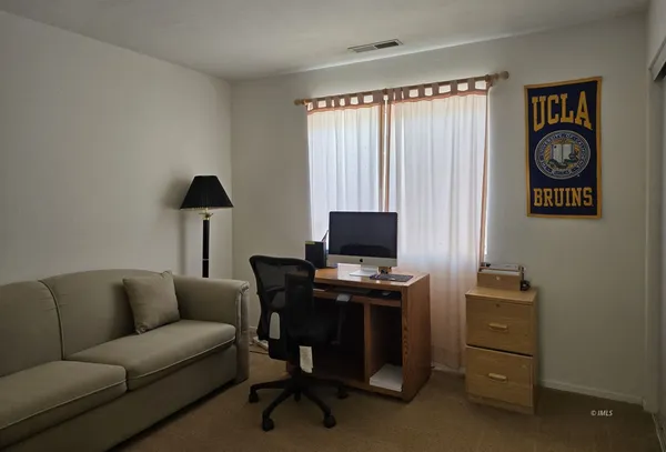 a livingroom with a workspace