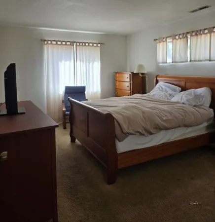 a bedroom with a bed and window