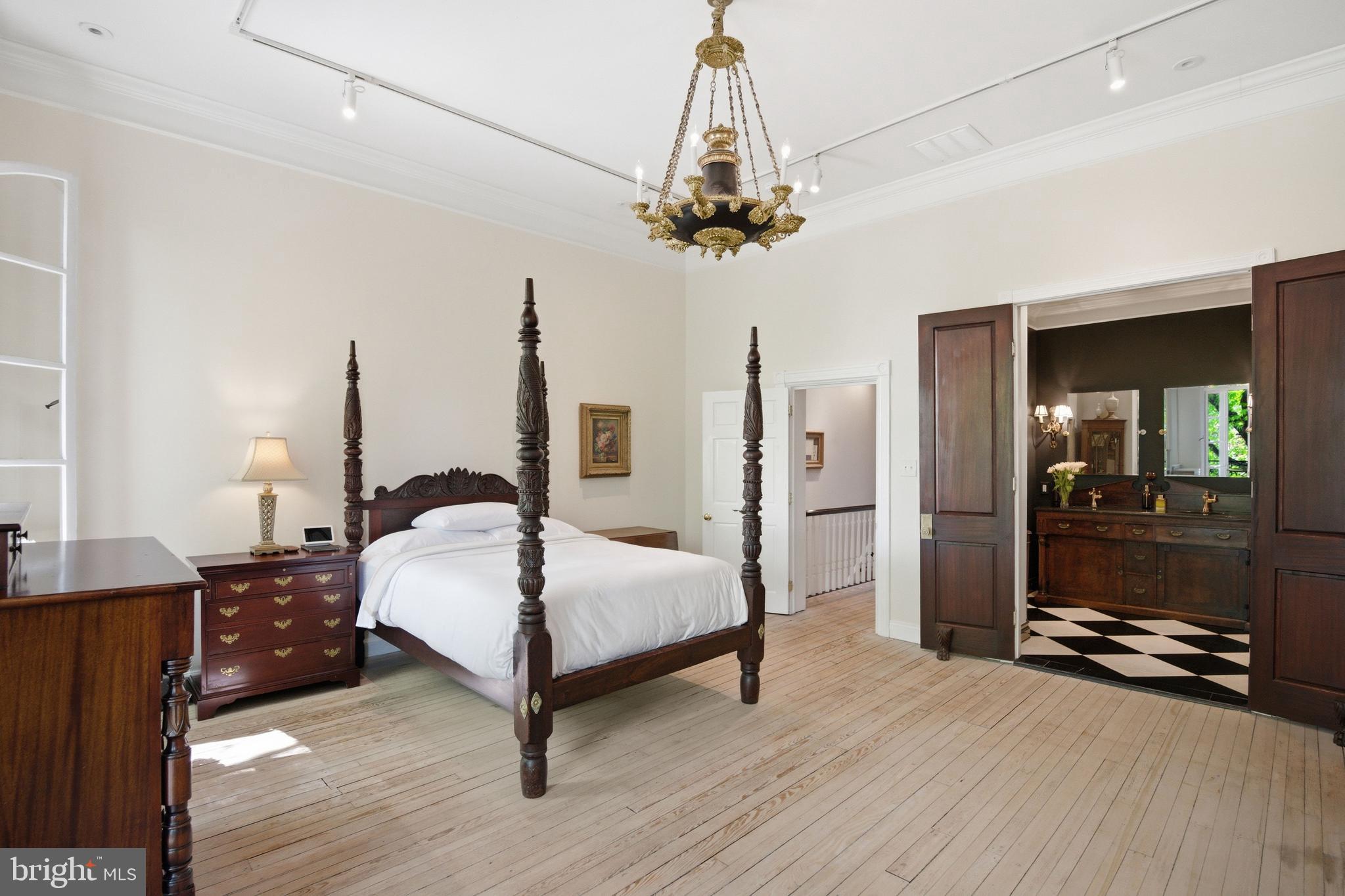 2815 Q Street Northwest Washington, DC 20007 - Photo 15 of 32 a bed room with a bed and a chandelier