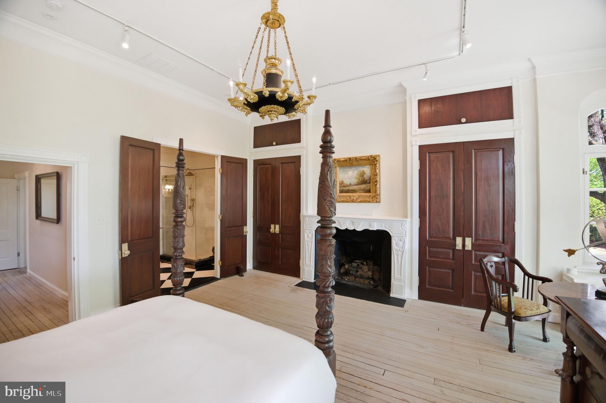 2815 Q Street Northwest Washington, DC 20007 - Photo 16 of 32 a bedroom with a bed and a chandelier