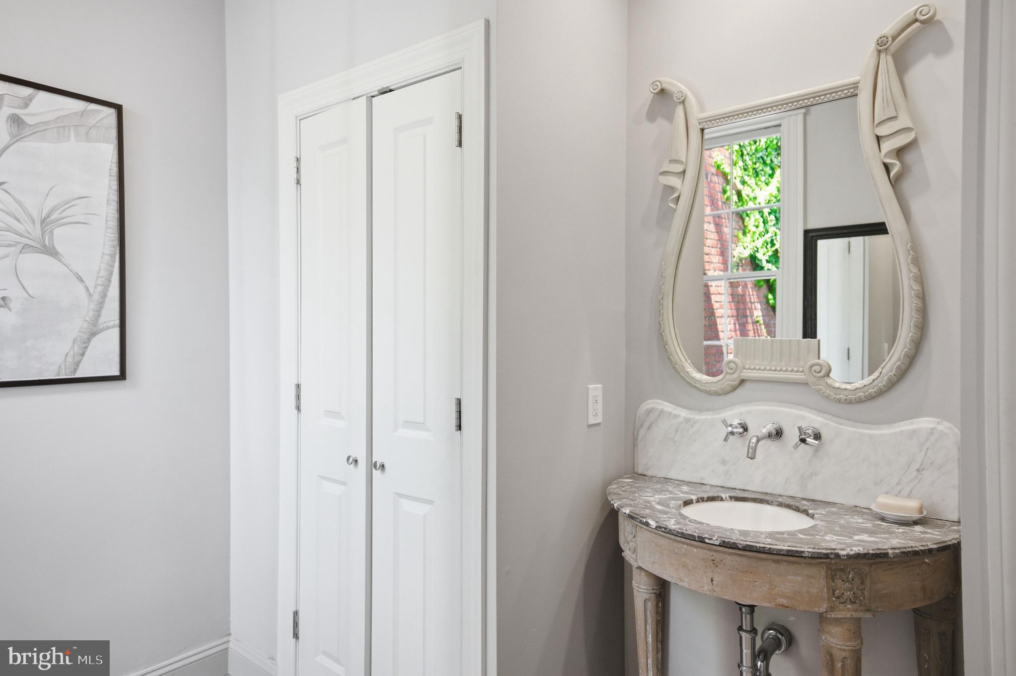 2815 Q Street Northwest Washington, DC 20007 - Photo 24 of 32 a bathroom with a granite countertop sink and a mirror