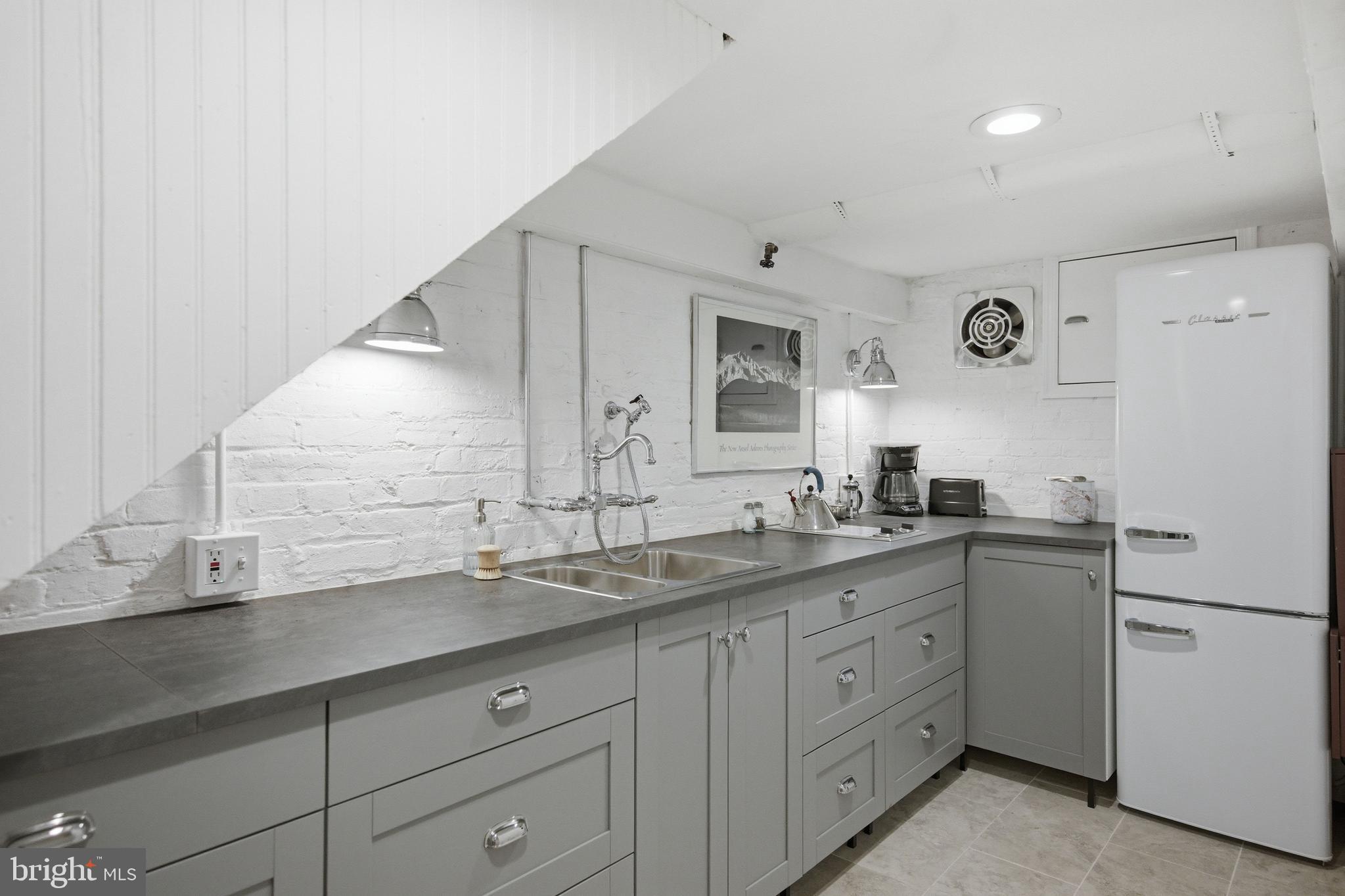 2815 Q Street Northwest Washington, DC 20007 - Photo 28 of 32 a spacious bathroom with a granite countertop sink and a mirror