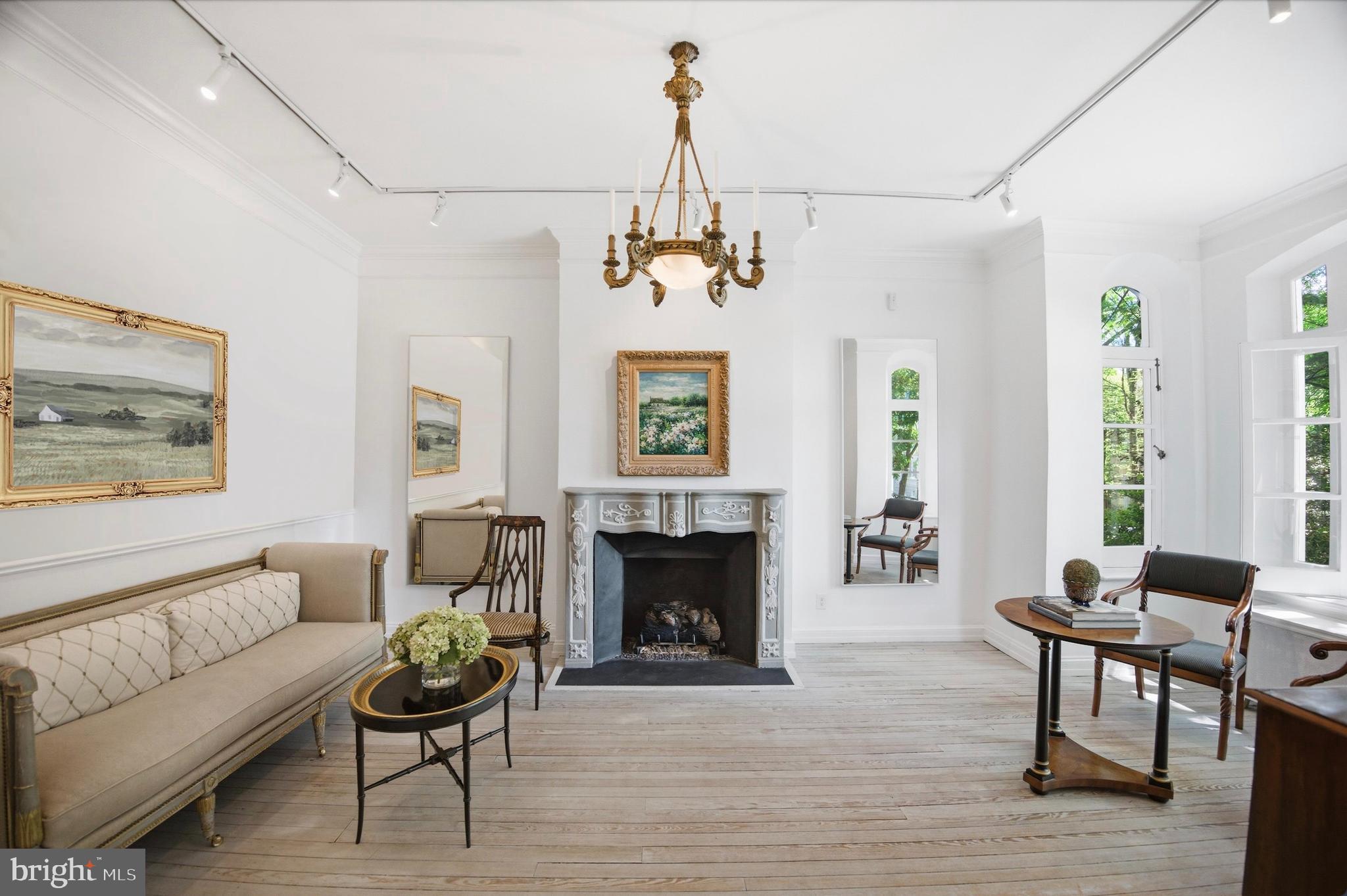 2815 Q Street Northwest Washington, DC 20007 - Photo 3 of 32 a living room with furniture a fireplace and a chandelier