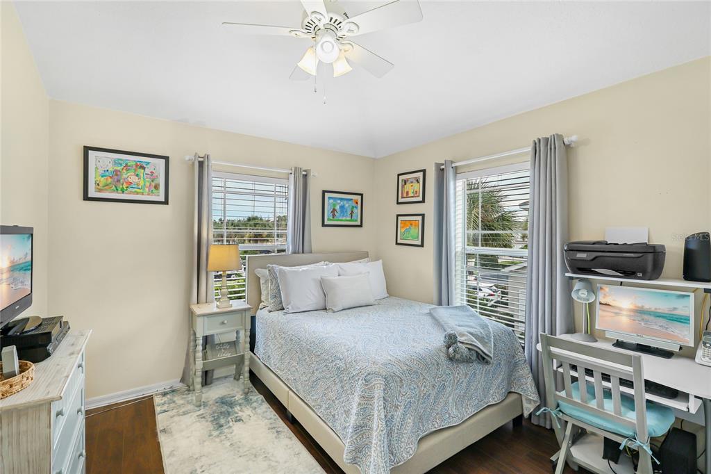 14847 Skip Jack Loop Lakewood Ranch, FL 34202 - Photo 16 of 26 a bedroom with a bed and a flat tv screen on the dresser