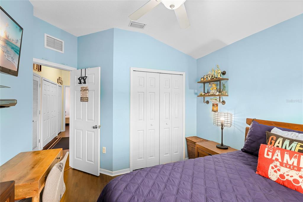 14847 Skip Jack Loop Lakewood Ranch, FL 34202 - Photo 18 of 26 a bedroom with a bed and wooden floor