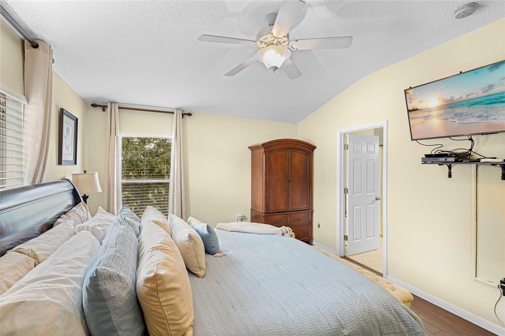 14847 Skip Jack Loop Lakewood Ranch, FL 34202 - Photo 21 of 26 a bed sitting in a bedroom next to a window