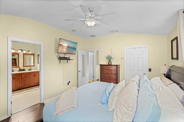 a spacious bedroom with a bed and a chandelier