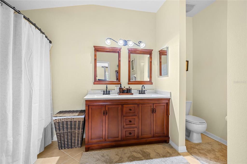 14847 Skip Jack Loop Lakewood Ranch, FL 34202 - Photo 23 of 26 a bathroom with a sink and a mirror