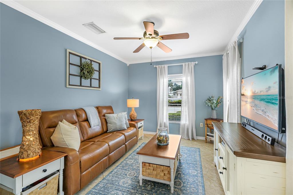 14847 Skip Jack Loop Lakewood Ranch, FL 34202 - Photo 3 of 26 a living room with furniture and a flat screen tv