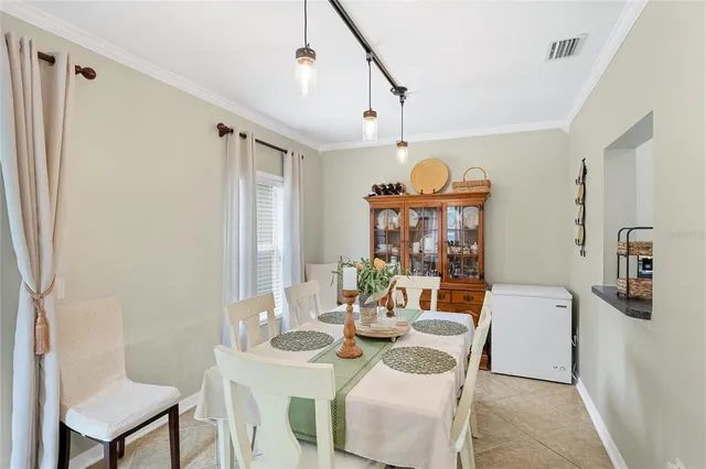 a view of a dining room with furniture and a chandelier