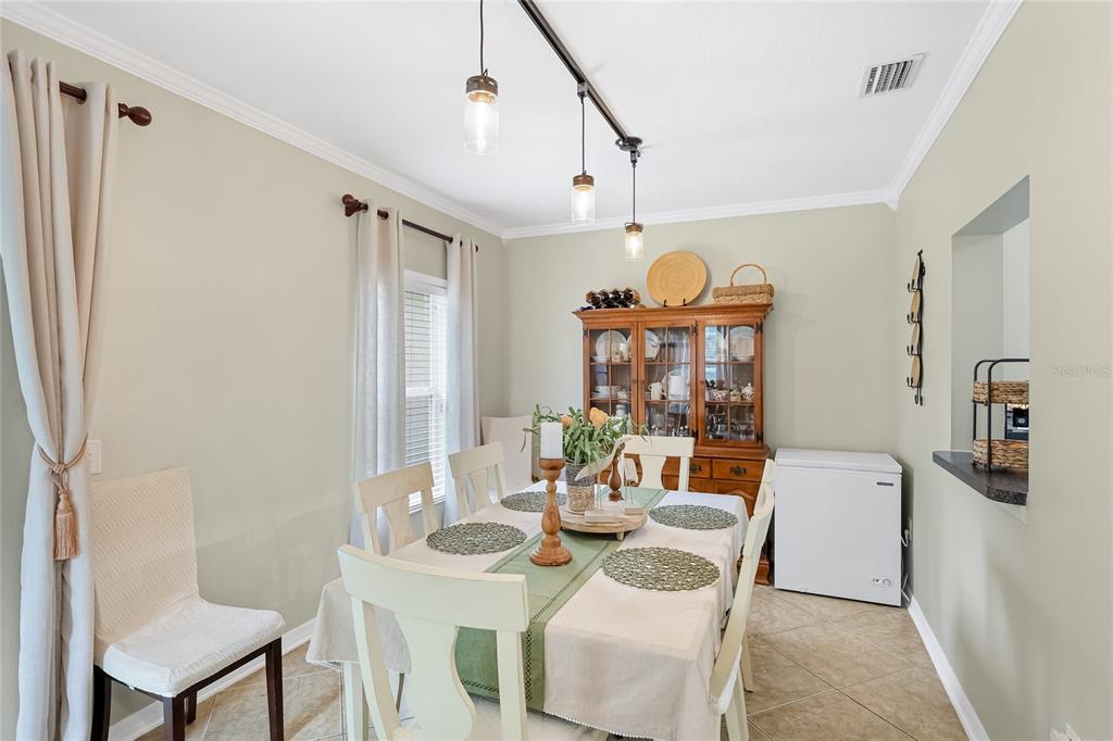 14847 Skip Jack Loop Lakewood Ranch, FL 34202 - Photo 5 of 26 a view of a dining room with furniture and a chandelier