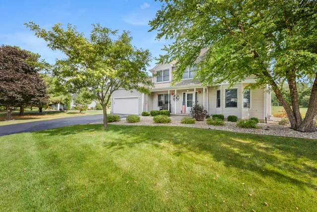 a front view of house with yard and green space