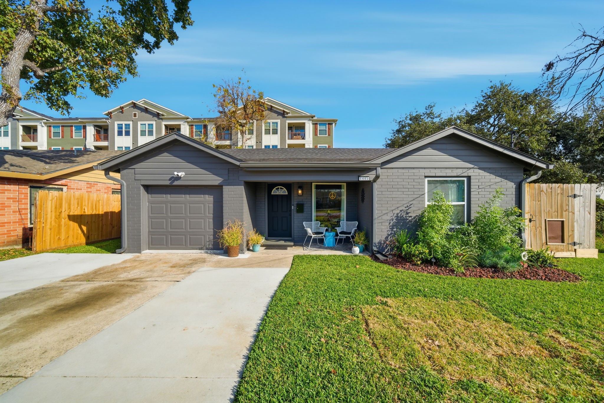 a front view of a house with yard and green space