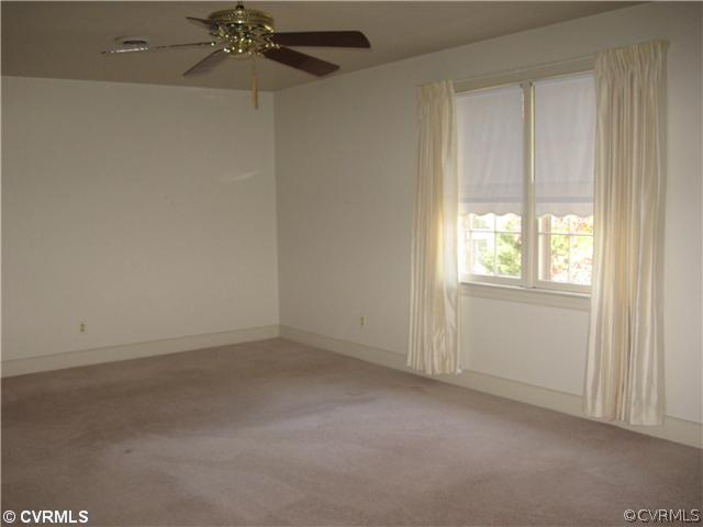 5224 Copperpenny Road Chesterfield, VA 23832 - Photo 9 of 12 an empty room with a chandelier fan and windows