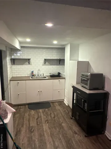 a kitchen with granite countertop a stove and a refrigerator