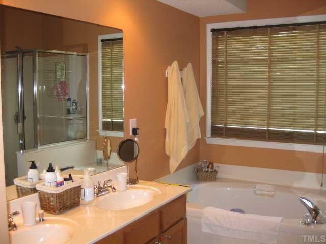 5416 Staysail Court Raleigh, NC 27613 - Photo 9 of 12 a bathroom with a tub sink and mirror