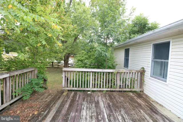 a view of a balcony with wooden floor