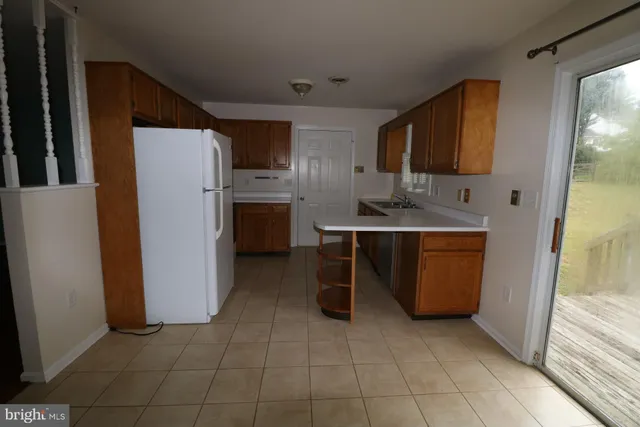 a kitchen with stainless steel appliances a refrigerator and a stove