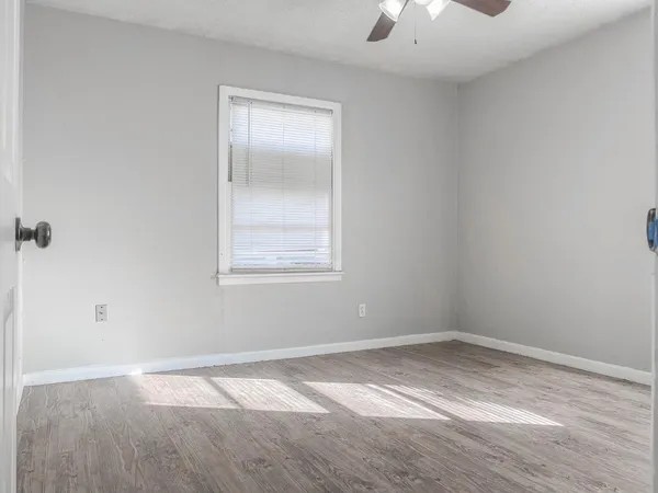 an empty room with a empty space and windows