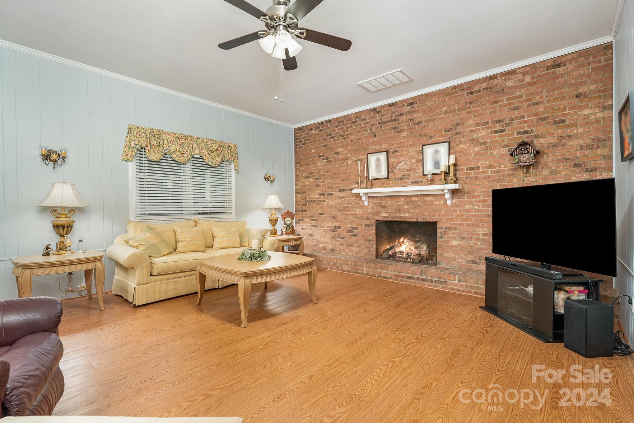 6308 Sunset Circle Charlotte, NC 28216 - Photo 12 of 30 a living room with furniture a flat screen tv and a fireplace