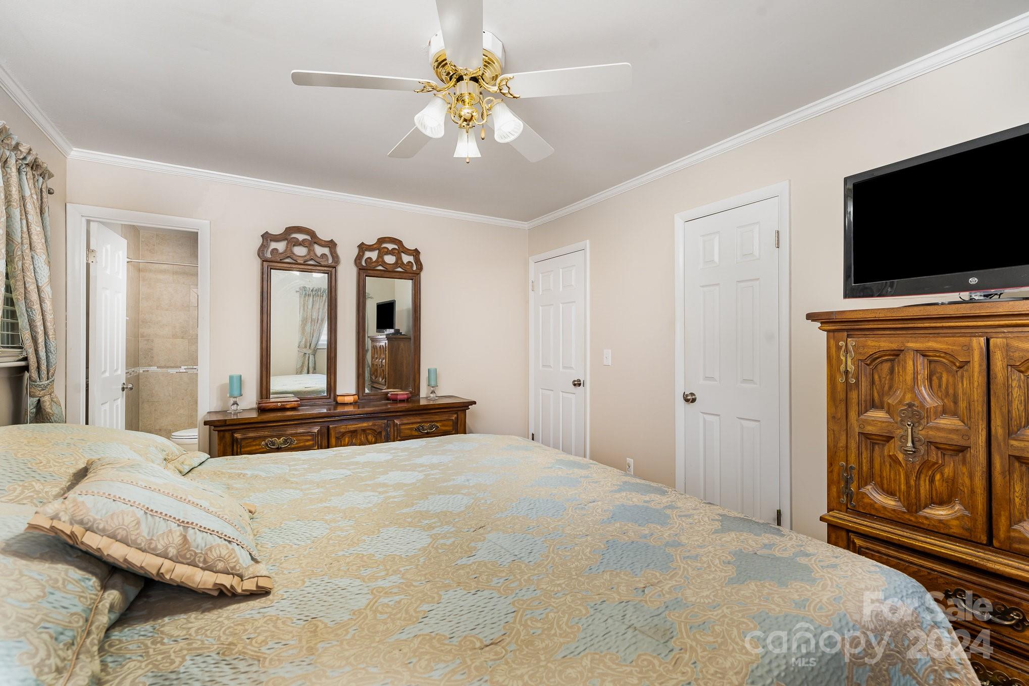 6308 Sunset Circle Charlotte, NC 28216 - Photo 15 of 30 a bedroom with a bed a flat screen tv and dresser