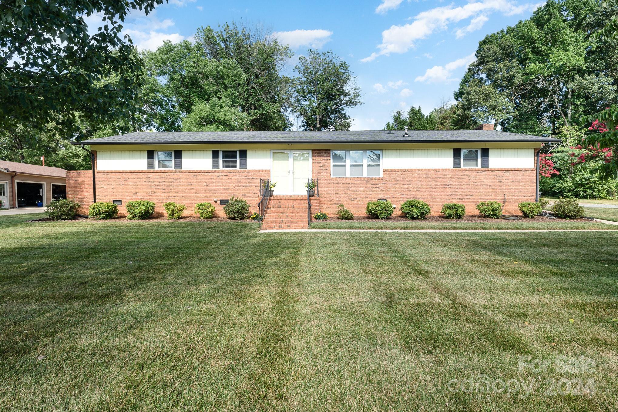 6308 Sunset Circle Charlotte, NC 28216 - Photo 2 of 30 a front view of a house with a yard