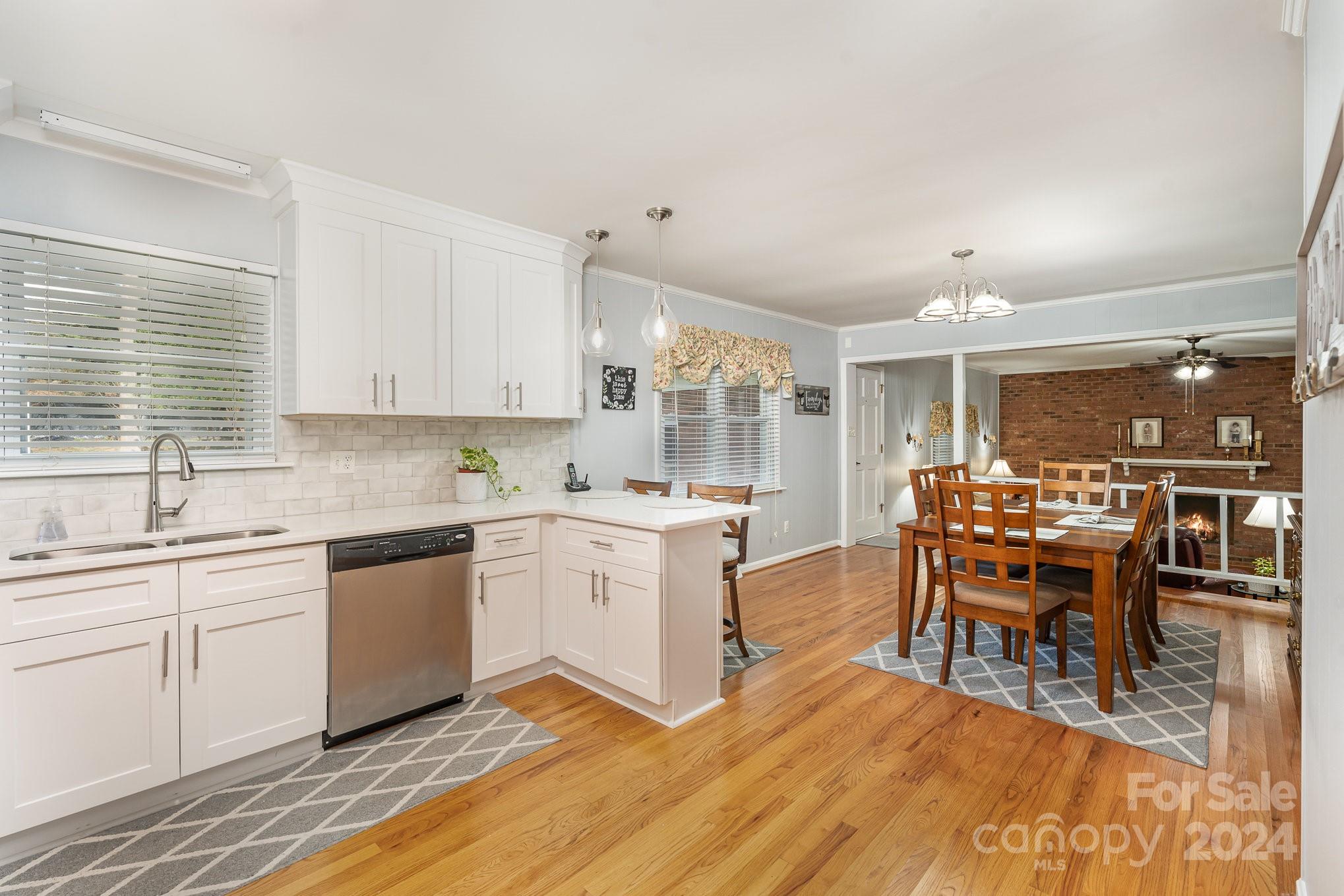 6308 Sunset Circle Charlotte, NC 28216 - Photo 6 of 30 a kitchen with stainless steel appliances granite countertop a table chairs sink and cabinets