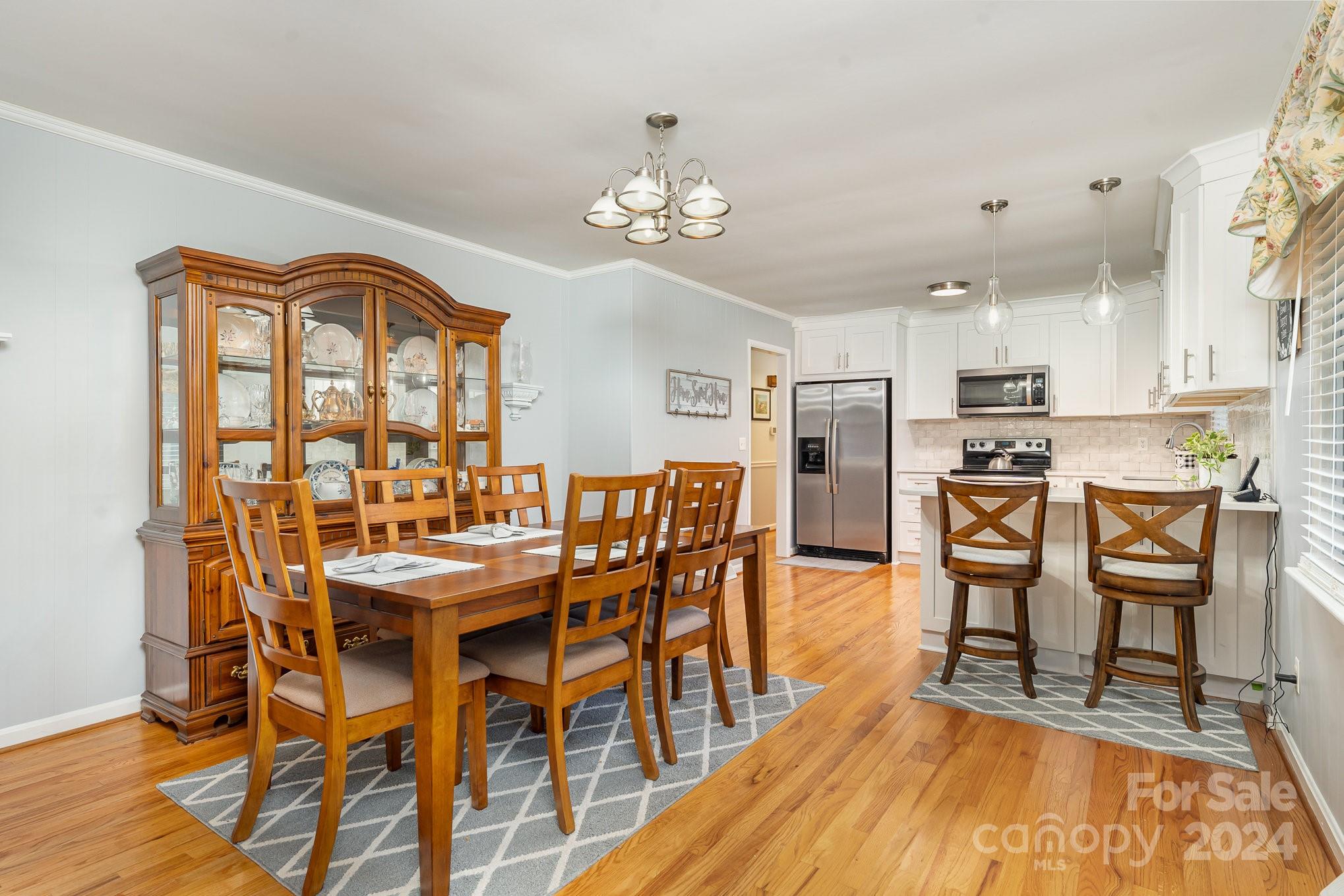 6308 Sunset Circle Charlotte, NC 28216 - Photo 9 of 30 a view of a dining room with furniture and chandelier