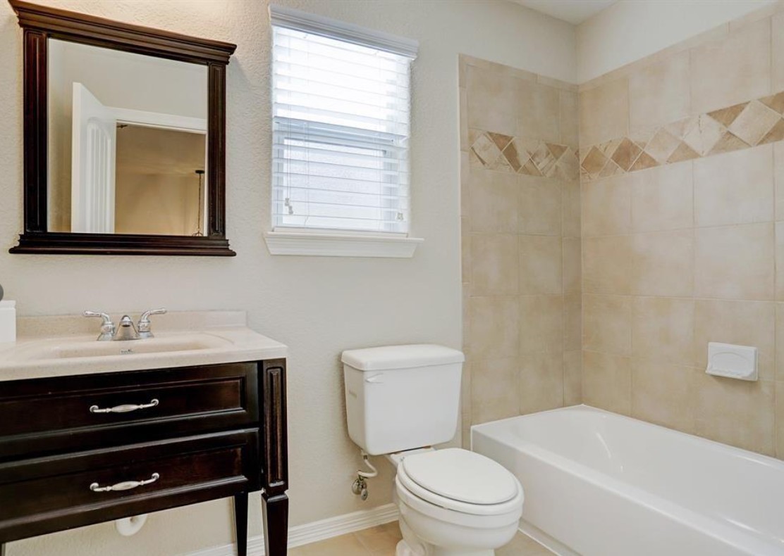277 Capetown Conroe, TX 77356 - Photo 9 of 10 Well-appointed secondary bathroom featuring a tiled tub/shower combo, elegant vanity, and bright, clean finishes for everyday convenience.