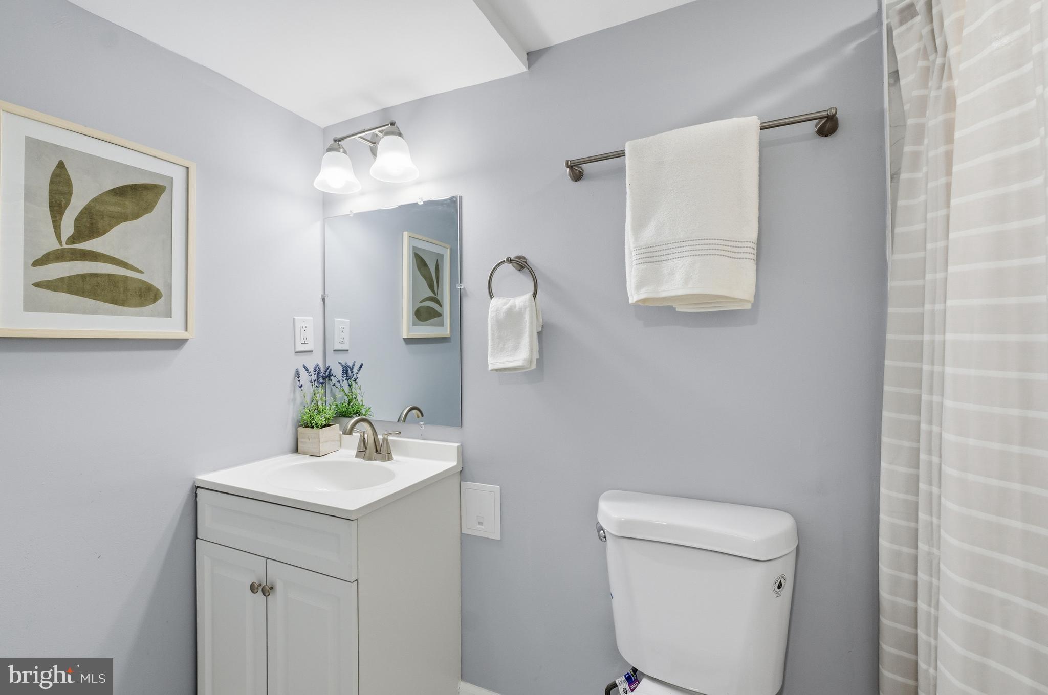 6 New County Road Aberdeen, MD 21001 - Photo 31 of 44 a bathroom with a toilet a sink and mirror