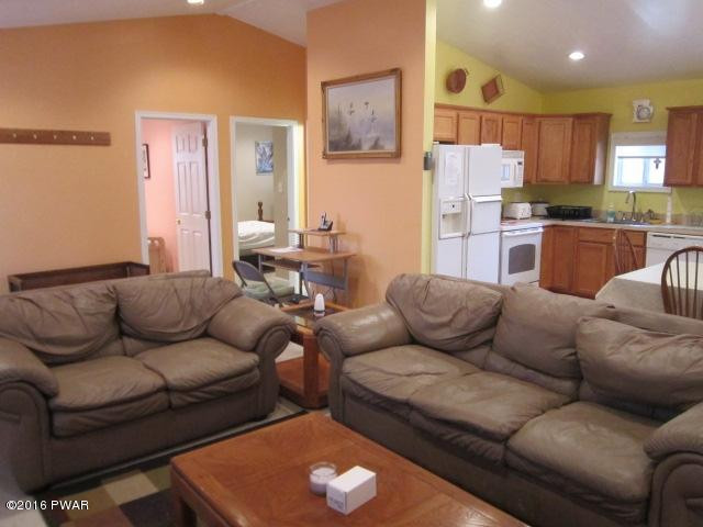 203 Westcolang Road Lackawaxen, PA 18435 - Photo 4 of 15 a living room with furniture and kitchen view